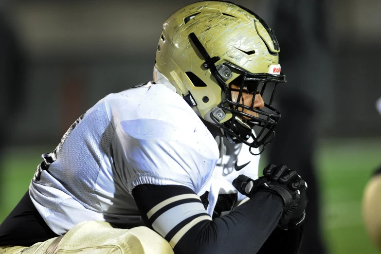 a young person with a helmet on playing football