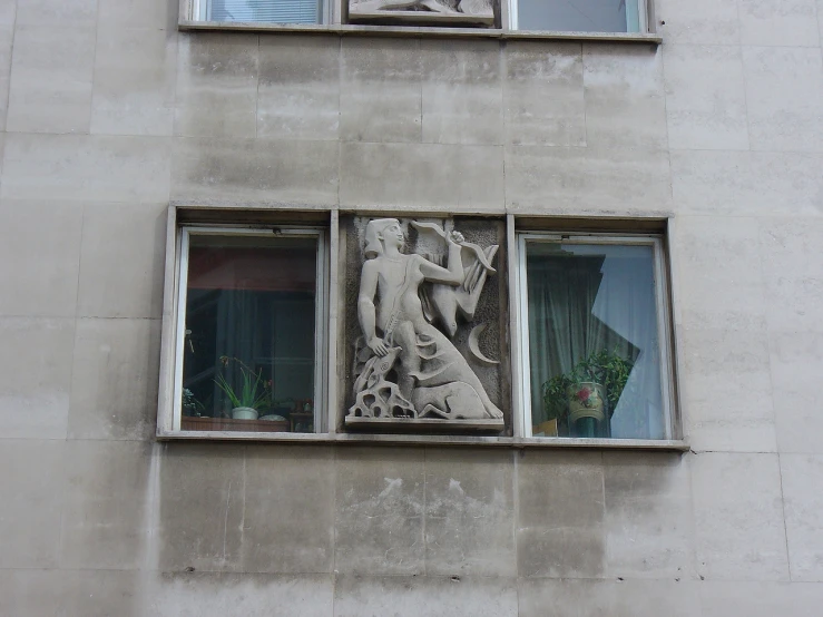 two windows with different designs on them that have a figure in them