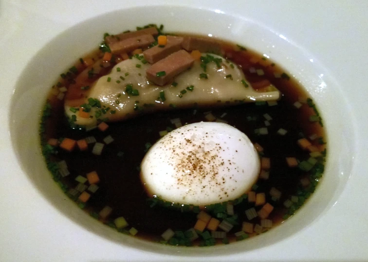 a bowl of soup with meat and vegetables