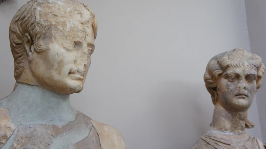 two statues with different colored heads near each other