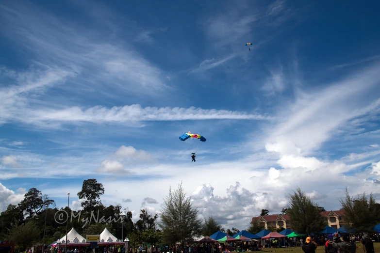 there is a large group of people flying kites