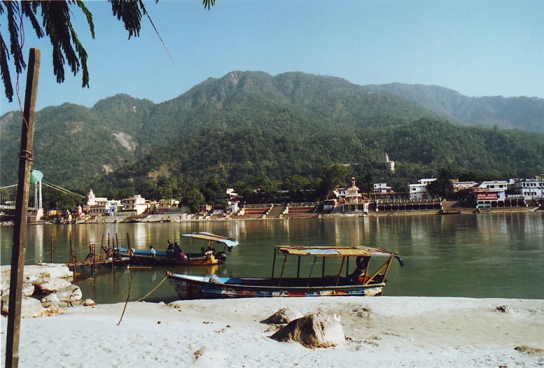 boats on the water near land and mountains