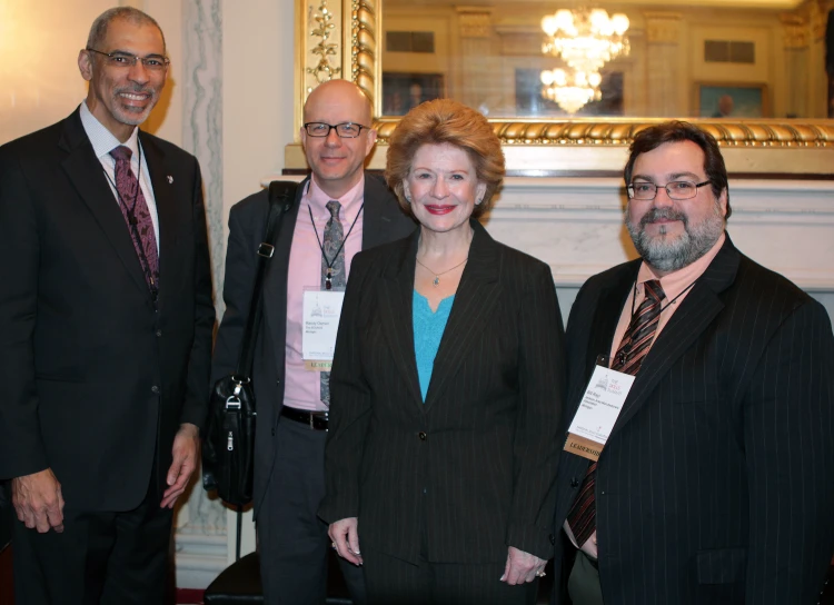 four businesspeople all dressed up for an event