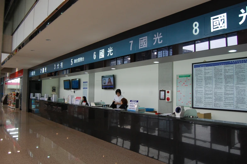 a large check - in desk with a sign in the background