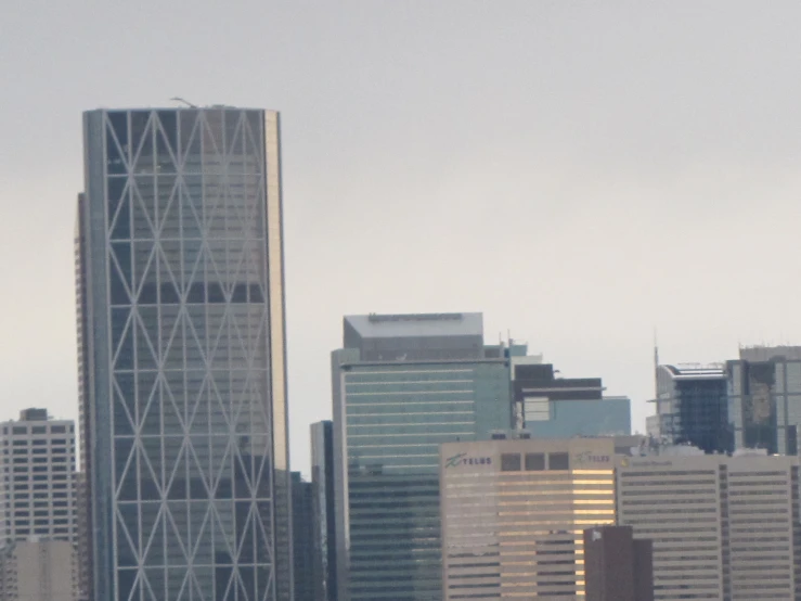 a view of several buildings from water with plane