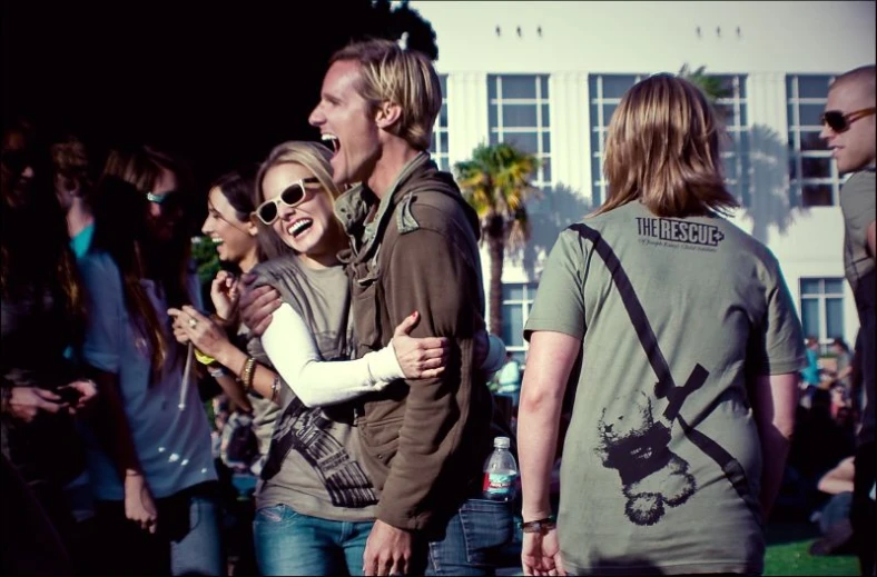 several people are standing together in front of a house