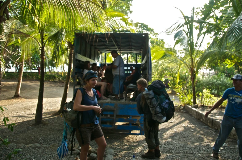 several people waiting in the truck for a bus to stop