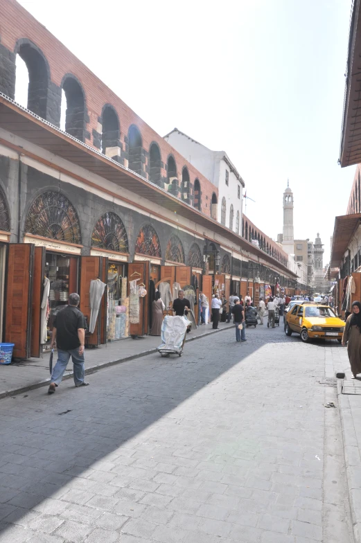 several people walking down an old town street