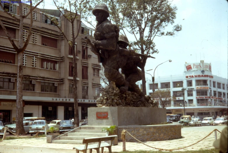 this is an outdoor sculpture of a man with a dog