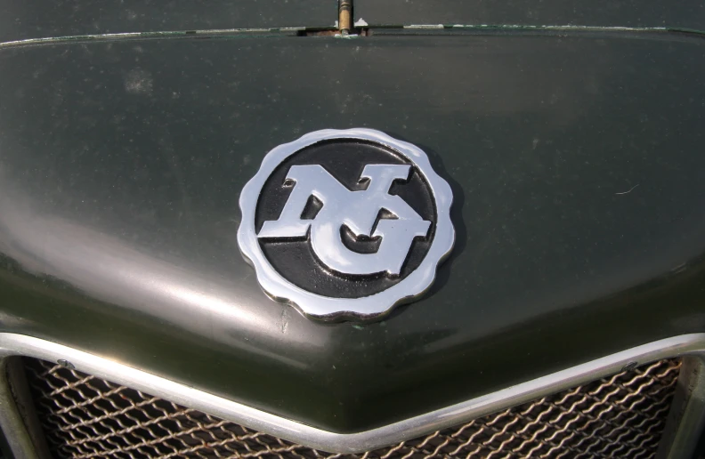 a closeup of a badge on the front of an old car