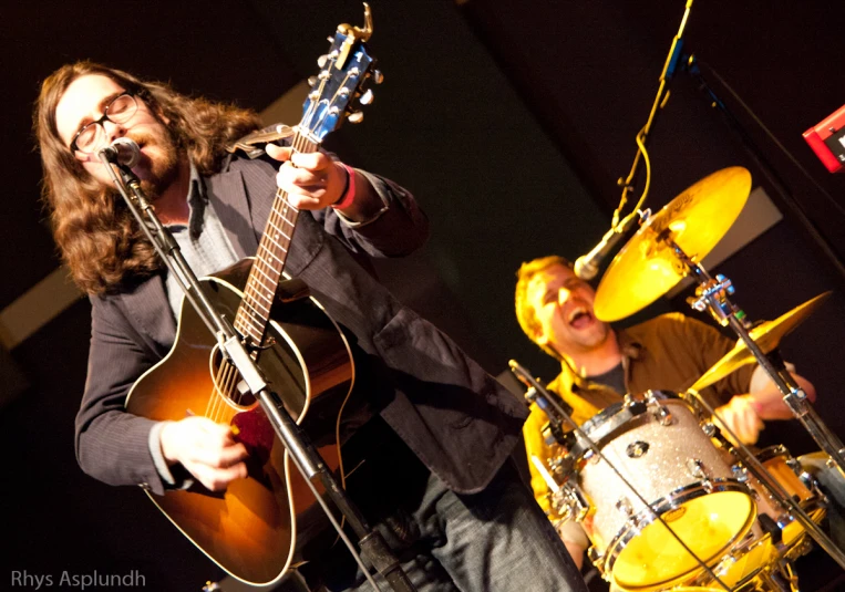 the musicians are playing instruments on stage