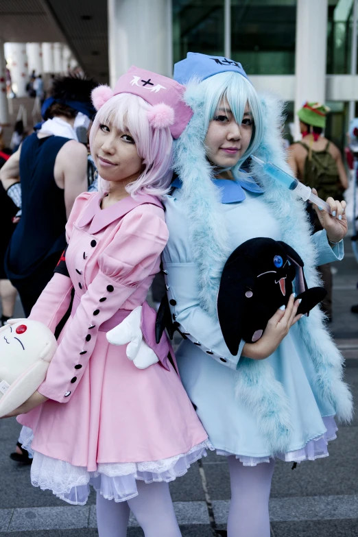 two women in costumes standing on a street