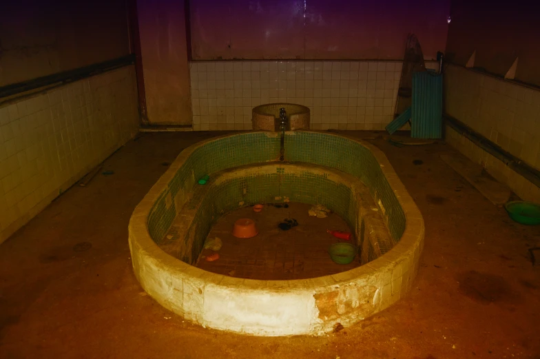 the old abandoned bathtub is full of trash