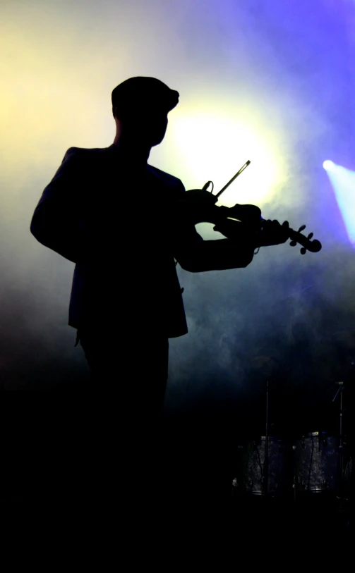 a musician with a violin in his hands