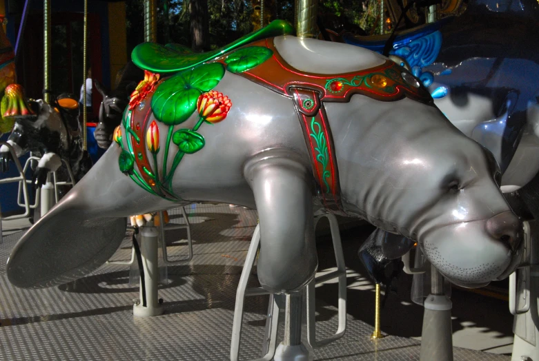 a carousel ride with elephants and flowers on their backs