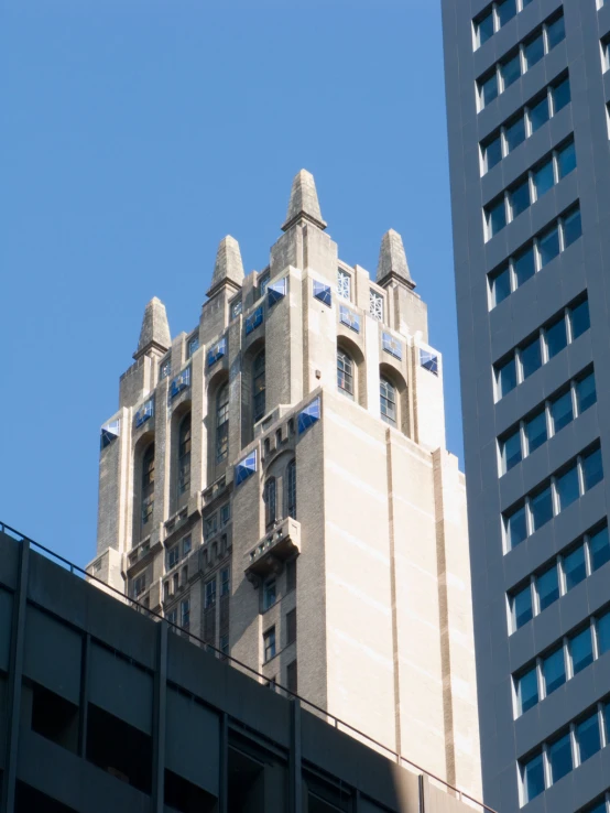 a tall building next to another building that has windows