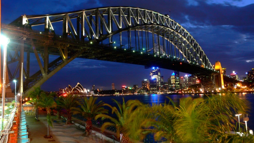 a bridge over the water that spans over a city