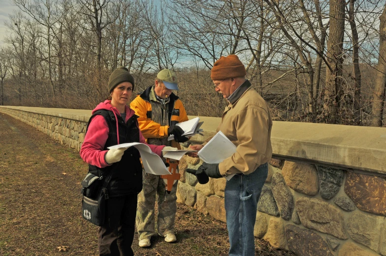 a man and woman are talking on a bridge