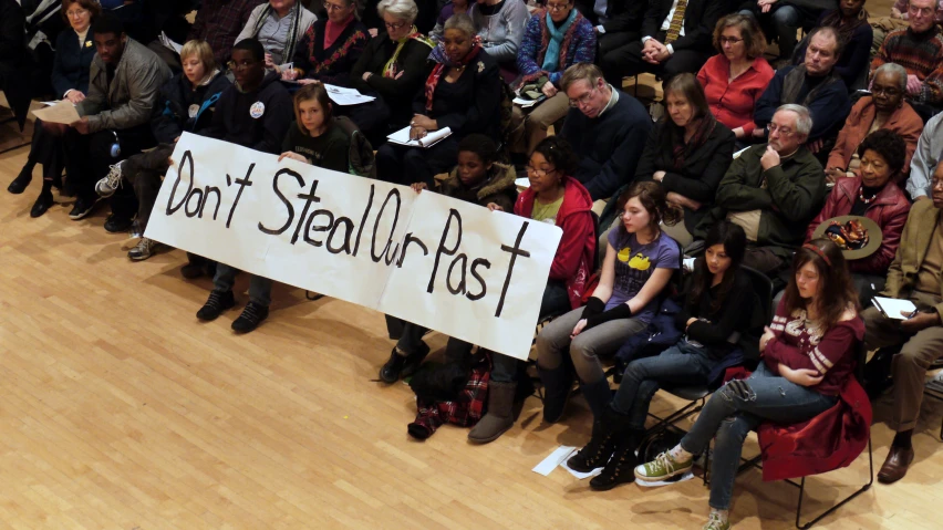 a group of people on the floor with a sign that says don't stand fast