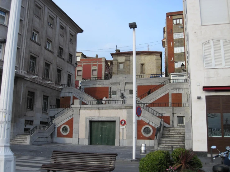 a large brick building with stairs leading up to the top floor