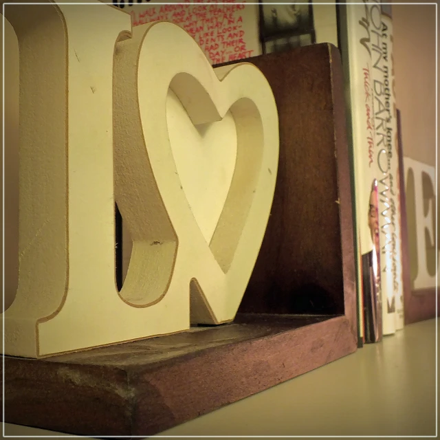 paper heart cut in the shape of an i love you letter