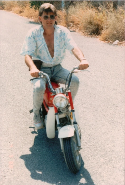 a man riding a red and white motorcycle