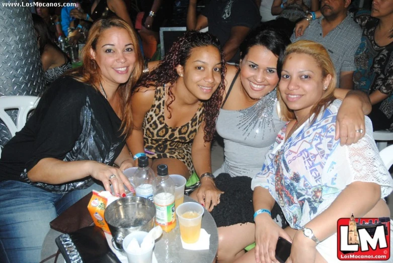 a group of people sitting around a table with drinks