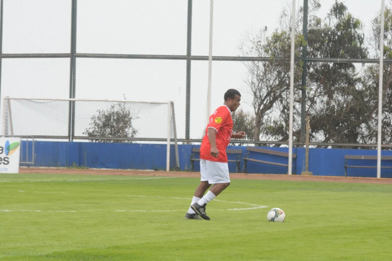 a soccer player kicking the ball in a field