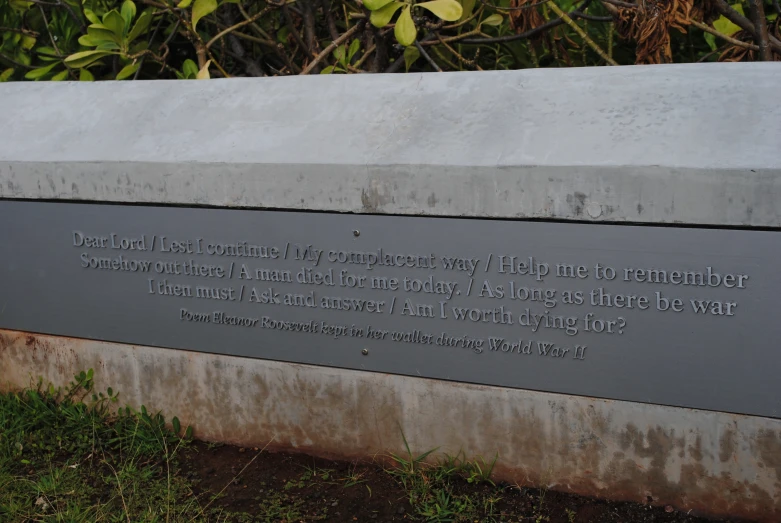 a stone wall with a poem written on it