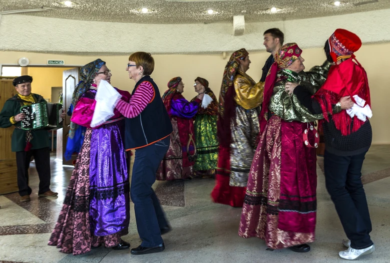 men and women in colorful clothing standing in line