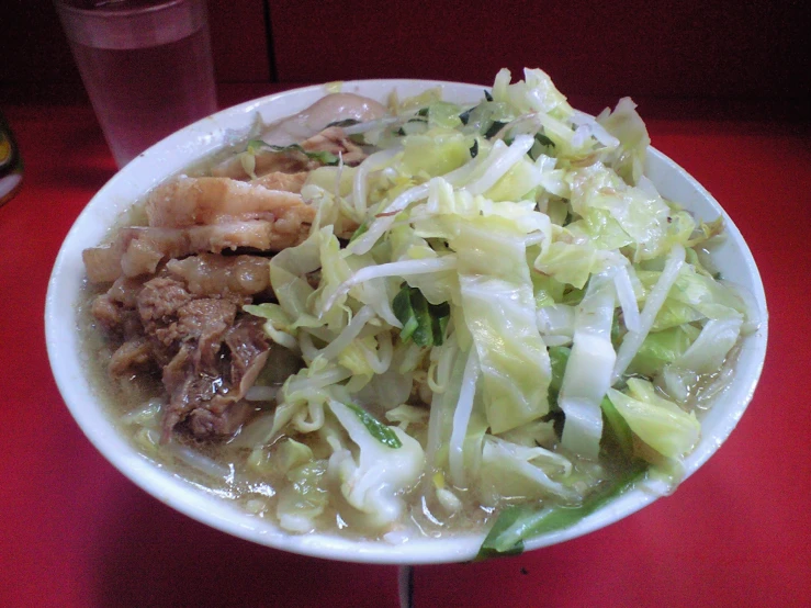a bowl of chinese noodle soup with cabbage