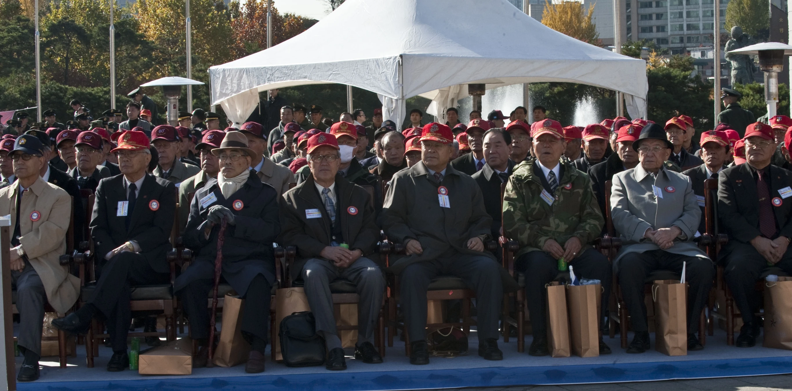 there are many men that are posing on benches