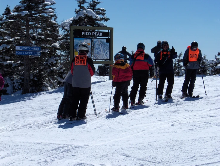 a bunch of people in ski equipment that are standing