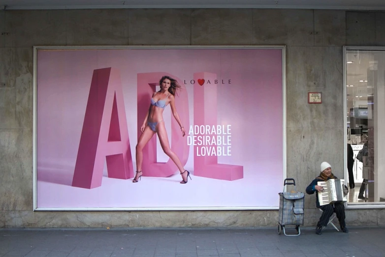 a billboard is shown for women at the corner of the sidewalk