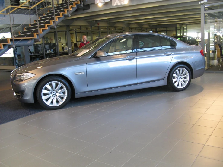 the silver car is on display in the showroom