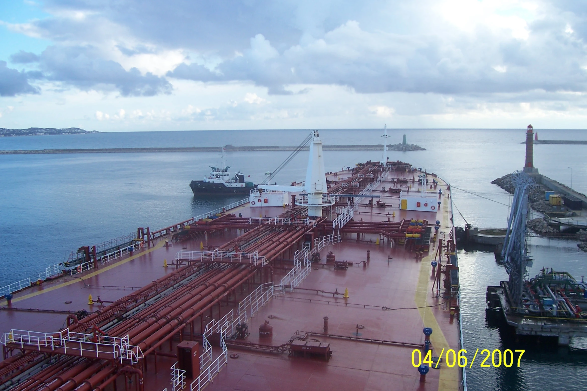 a large ship with lots of red pipes on the water