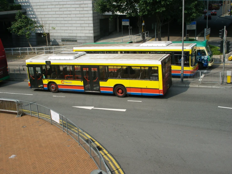 a yellow bus is traveling down the road