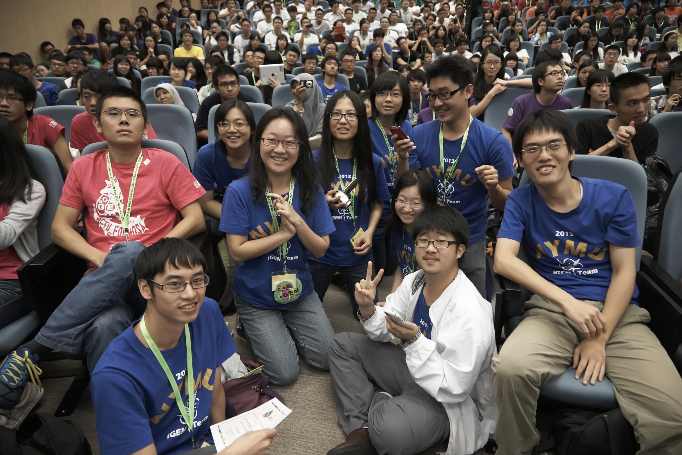 a group of people in rows sitting and standing together