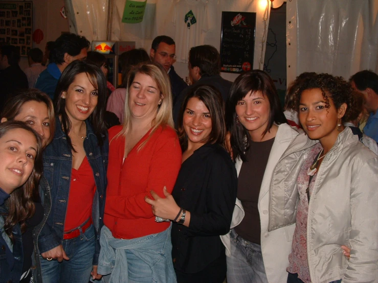 several women are smiling while posing for the camera