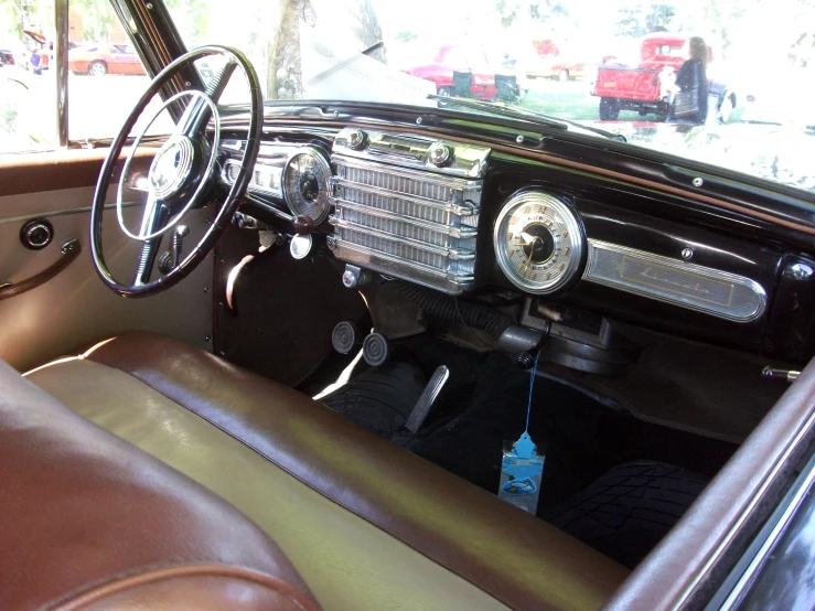 an interior of an older fashion vehicle showing the dashboard