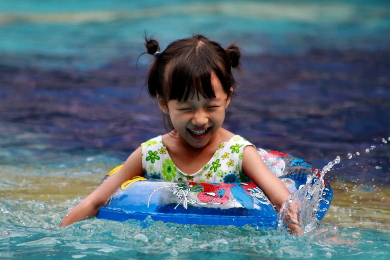 a child is floating in the water on an inner tube