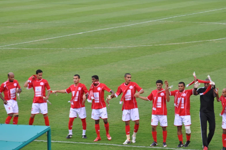 the soccer players are standing together on the field