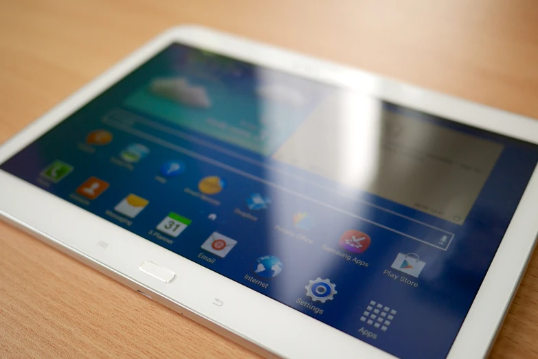 a small tablet sitting on top of a wooden table