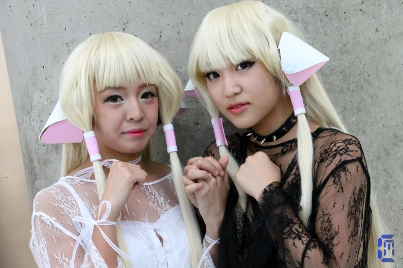 two women wearing pink wigs are posing for a po