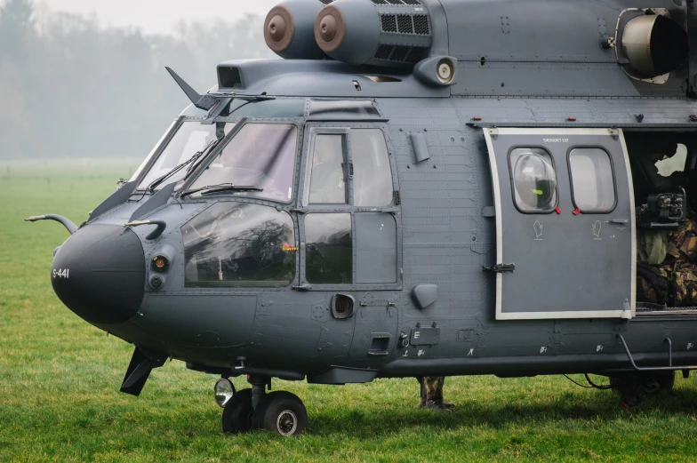 the door on a large gray helicopter is open