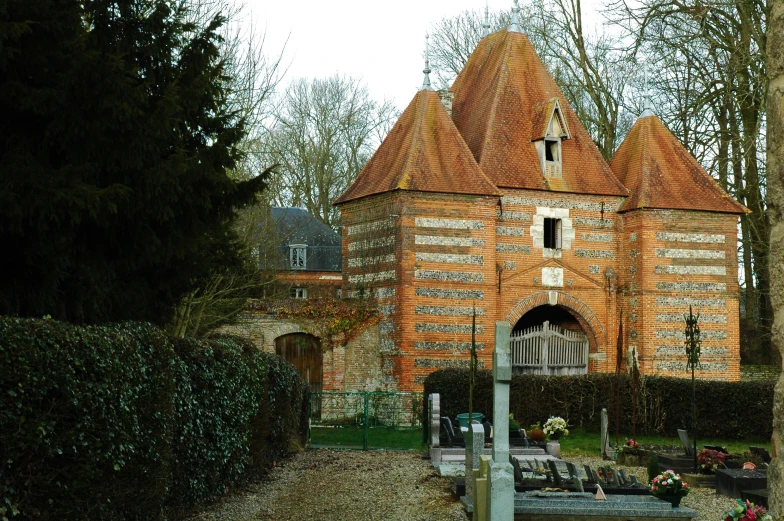 an ornate brick building with a gate and windows