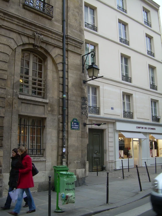 people walking in an urban area near large buildings