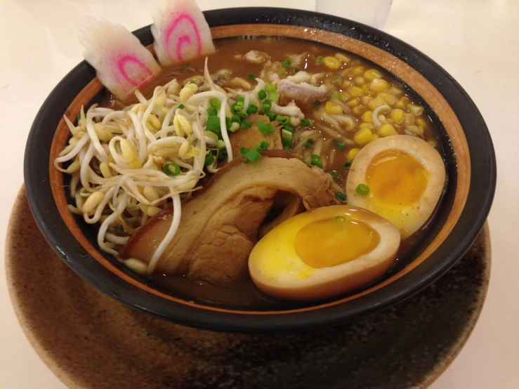 food inside of bowl with eggs, noodles and vegetables