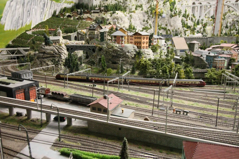 a model train set is shown with a miniature town on it