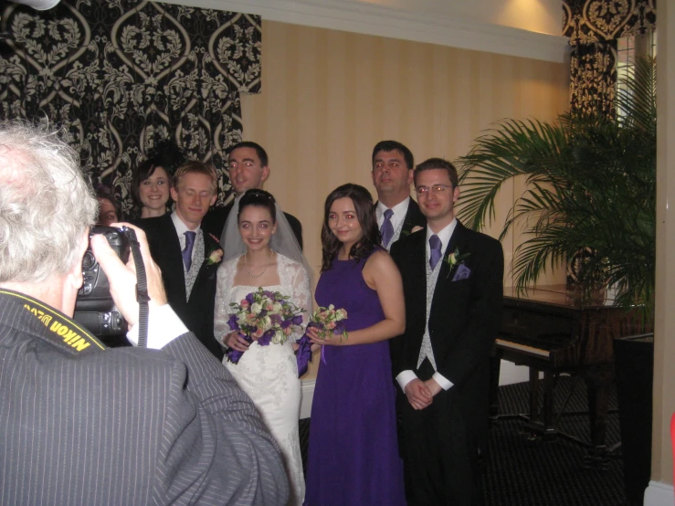 the couple are taking pictures with their wedding party